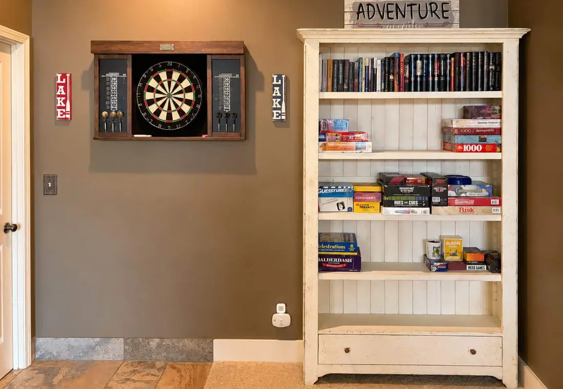 Dartboard and a bookcase of board games and puzzles