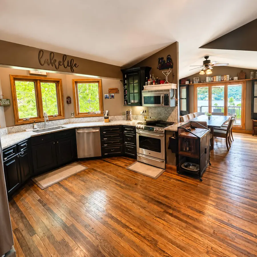 The kitchen, open to the dining area and the lake beyond