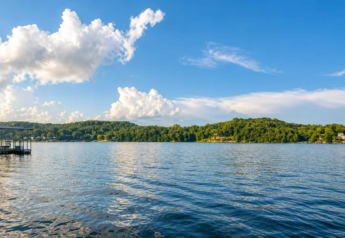 Open water and green shoreline under a big summer sky